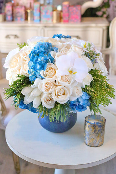 Winter-themed flower arrangement with delphinium, hyacinths, callas,  hydrangeas, roses,…