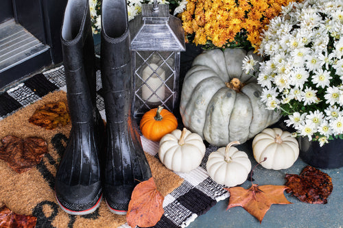 fall decors featuring boots, pumpkins, and chrysanthemums