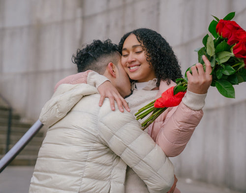 couples hugging with valentine's day roses